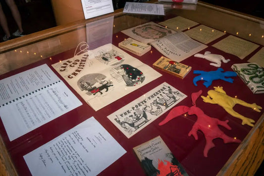 Edward Gorey memorabilia display with books, manuscripts, and colorful felt figures