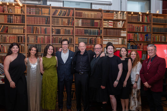 Group of people posing in front of bookshelves at Edward Gorey Online Shop event
