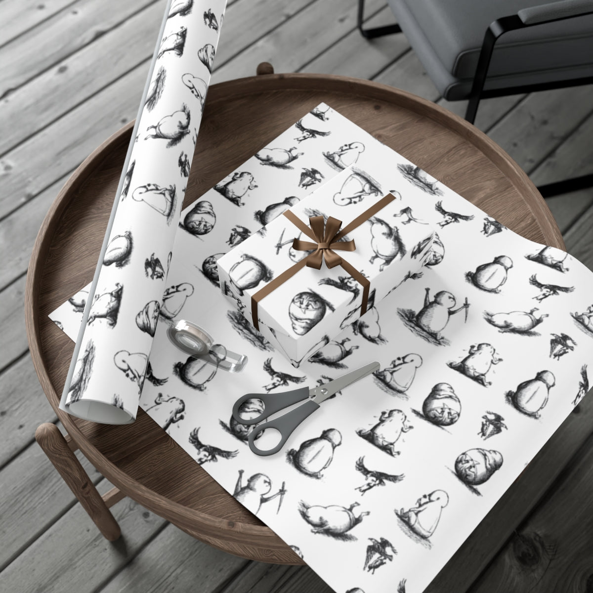 Edward Gorey gift wrap with whimsical black and white creatures, scissors, and wrapped present