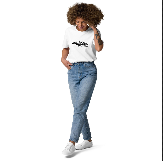 Woman wearing Edward Gorey Dracula Bat T-shirt and jeans, standing against white background