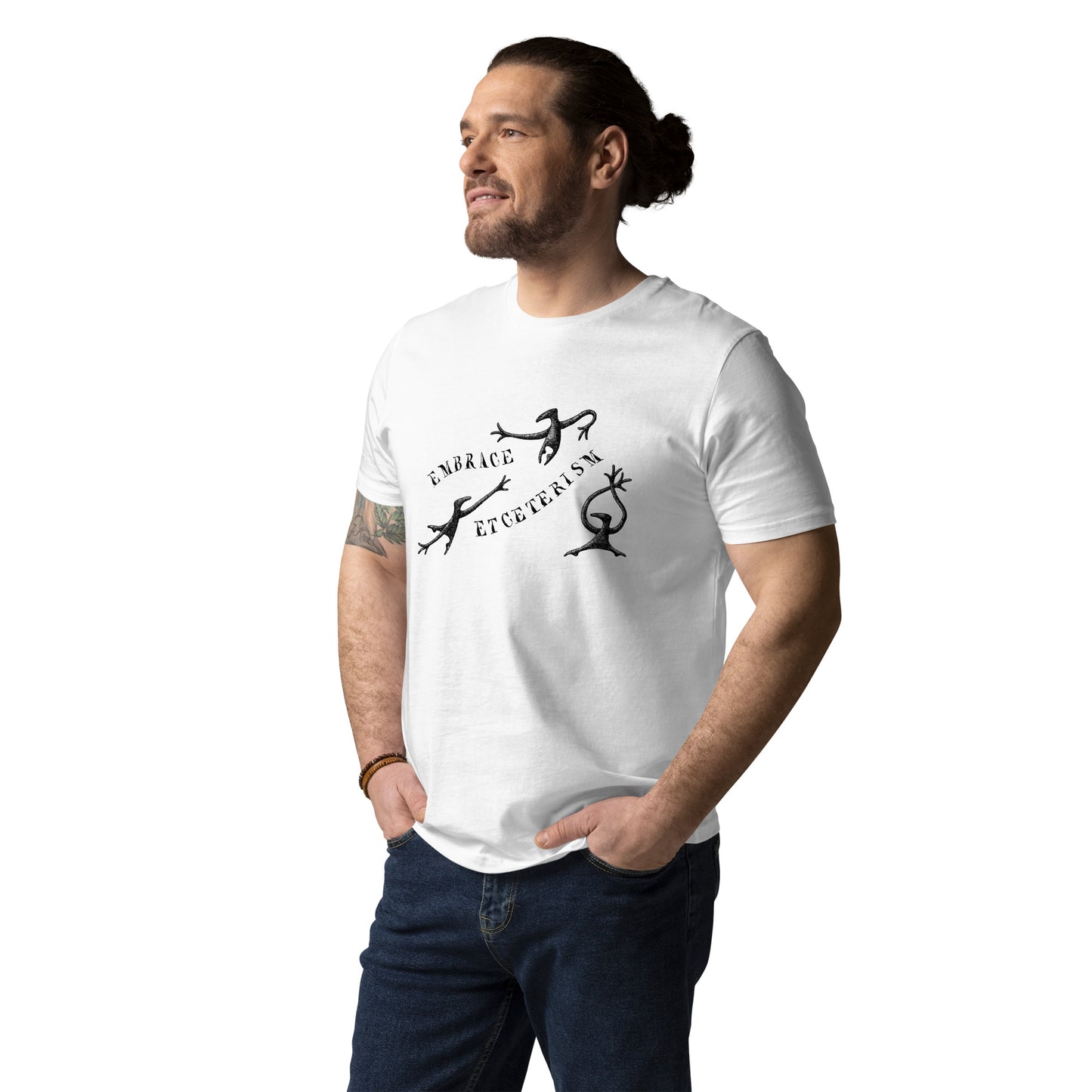 Man wearing white Embrace Etceterism T-shirt featuring Edward Gorey artwork, standing casually.