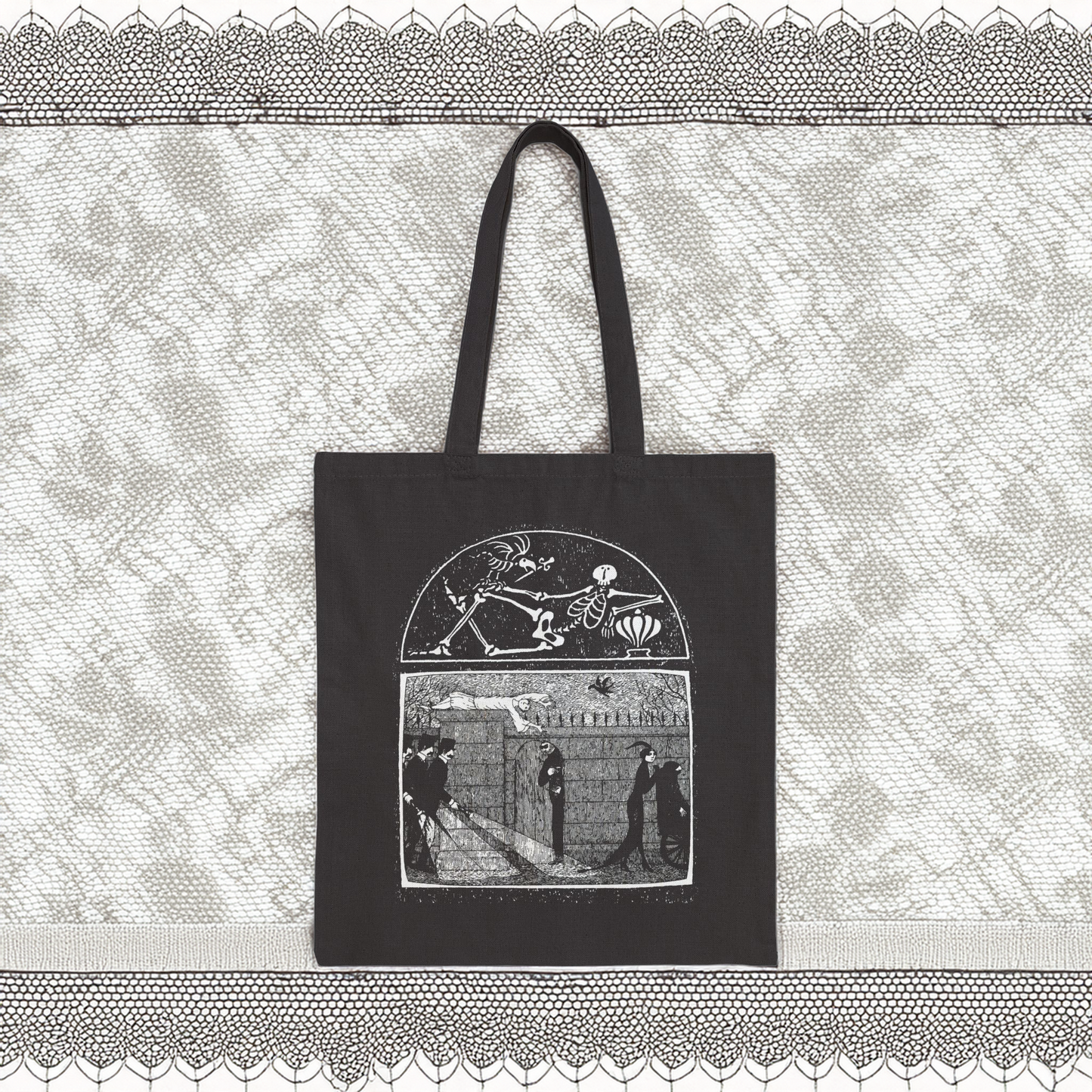 Edward Gorey black tote bag with gothic illustration, displayed on lace background