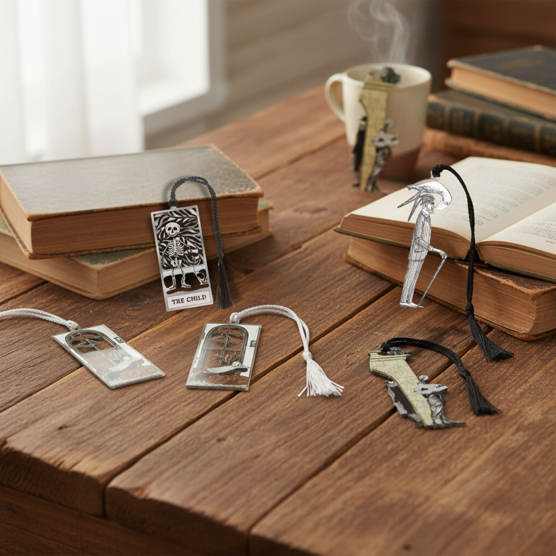 Edward Gorey metal bookmarks featuring The Child design on rustic wooden table with books