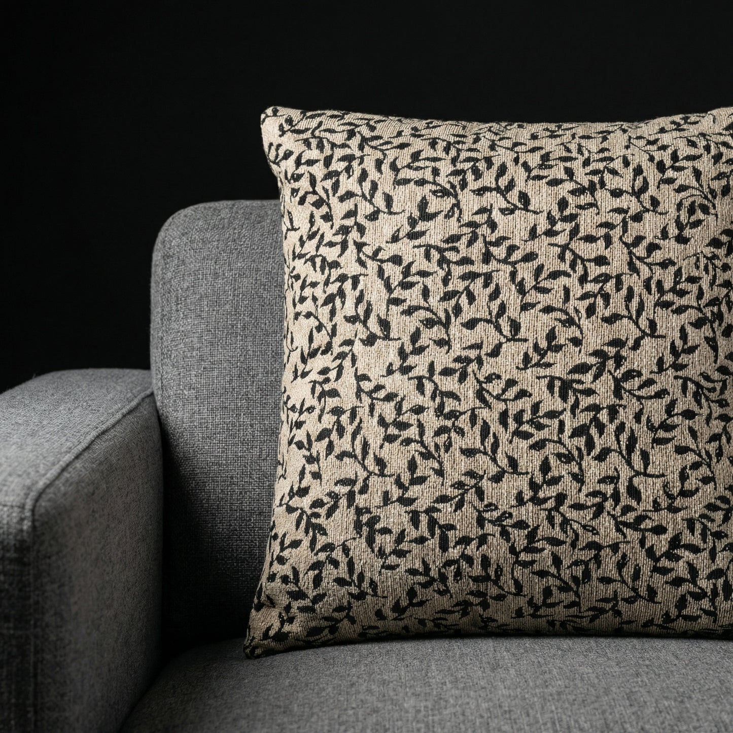 Beige woven cushion with black leaf pattern on gray sofa, Edward Gorey Online Shop home decor